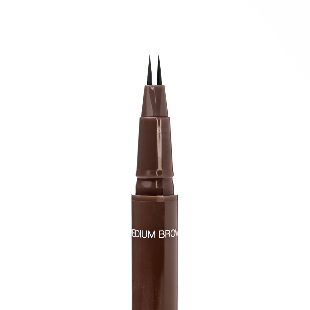 Close-up of the uncapped Palladio Brow Ink Micro Brow Pen in Medium Brown, showing the fine dual-precision brush tip and the "Medium Brown" shade label on the barrel.