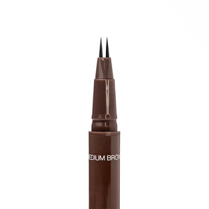 Close-up of the uncapped Palladio Brow Ink Micro Brow Pen in Medium Brown, showing the fine dual-precision brush tip and the "Medium Brown" shade label on the barrel.
