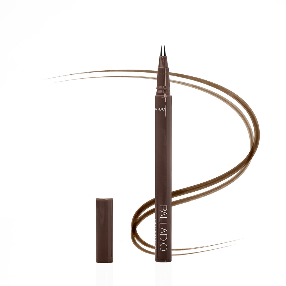 Palladio Brow Ink Micro Brow Pen in Medium Brown, an uncapped microblading-style pen with fine dual tips beside its cap, with a swooping medium brown line illustrating hair-like brow strokes.
