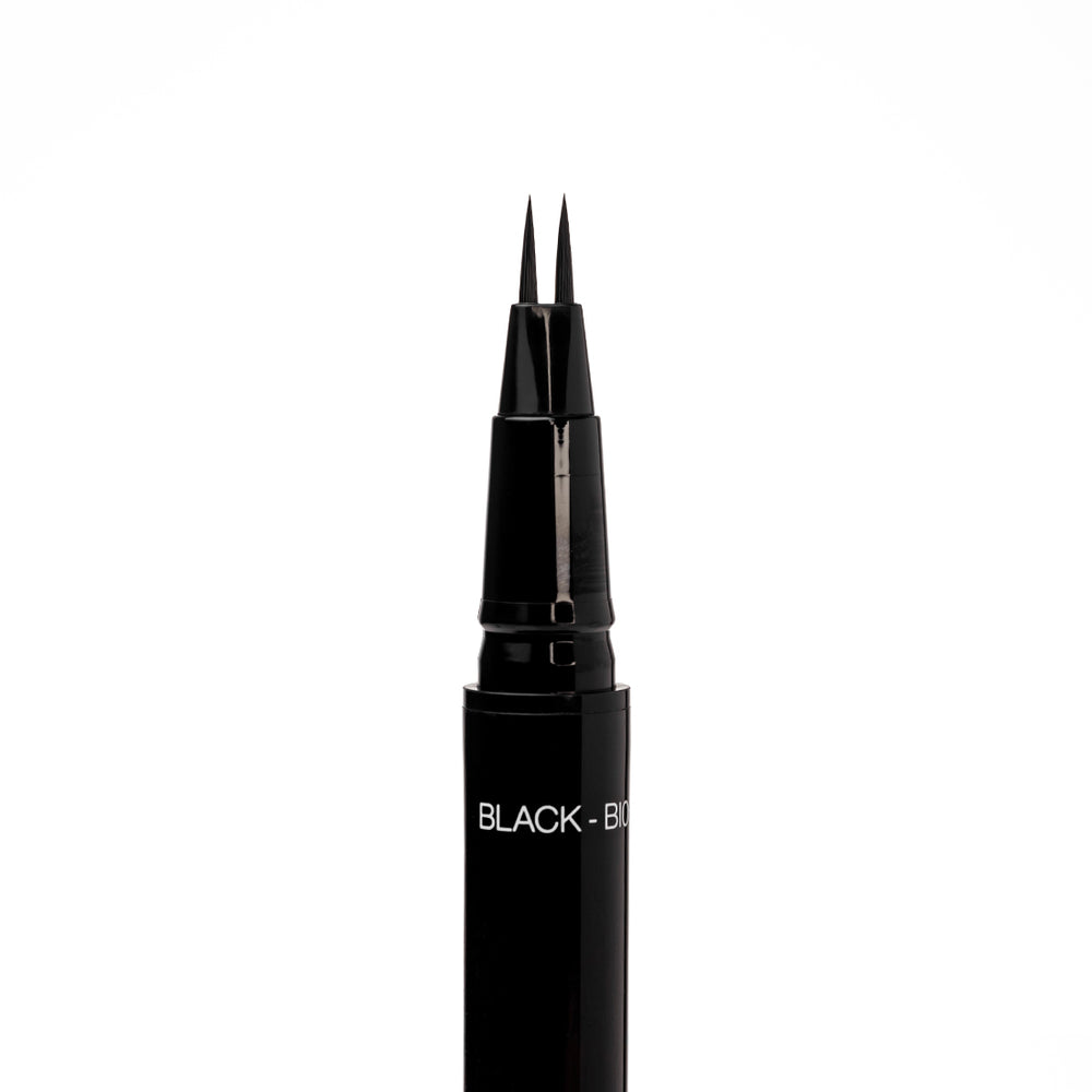 Close-up of the uncapped Palladio Brow Ink Micro Brow Pen in Black, showing the fine dual-precision brush tip and the "Black - BI05" shade label on the barrel.