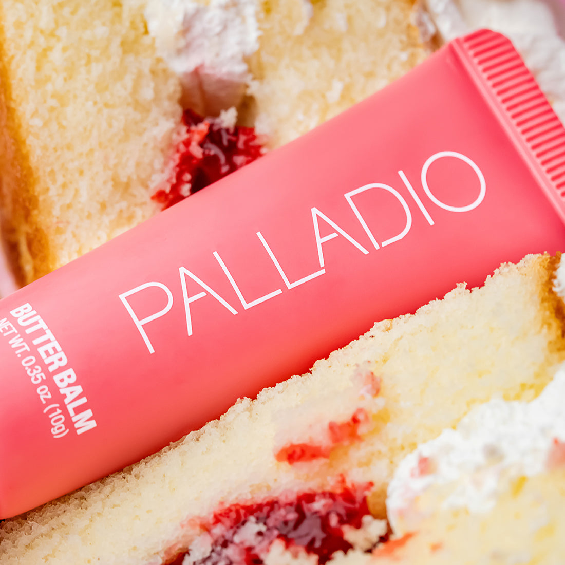 Butter Balm in shade Strawberry Shortcake lay on top of a cake.