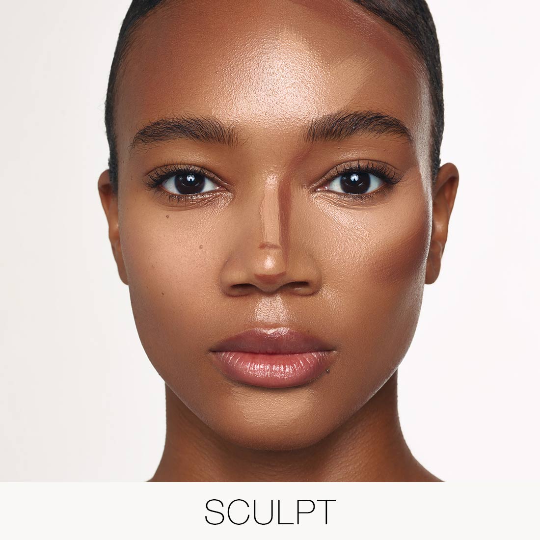 Model wearing Palladio Multi Face Palette in Tan-to-Dark with contour and highlight placement to add dimension.
