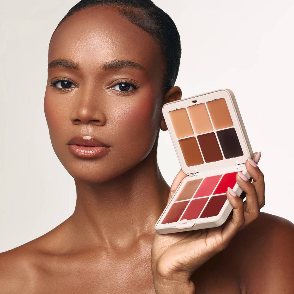 Model holding the open Palladio Multi Face Palette MFP02 Tan to Deep to show the complexion and color shades.
