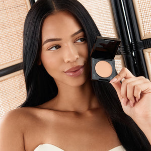 Model wearing Palladio Under Eye Brightener in Medium Nude shade.
