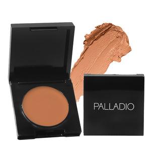 Palladio Under Eye Brightener compact in shade Golden Tan with cream texture swatch.